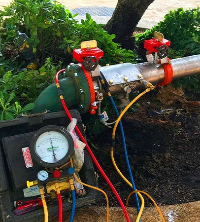 Plumber conducting backflow testing services