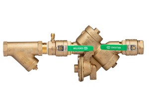Image showing the Wilkins 975XL2, a backflow preventer valve used in plumbing systems. It consists of a cylindrical body with inlet and outlet pipes. The device is designed to prevent the backflow of water, ensuring the safety and purity of the water supply.