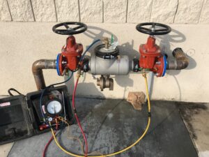 "Hayward backflow testing: Plumbers inspecting plumbing systems to ensure proper functioning of backflow prevention devices for water safety."
