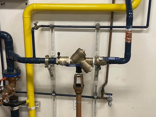 Image: A technician performing backflow testing in Stockton, ensuring water safety and compliance with regulations.